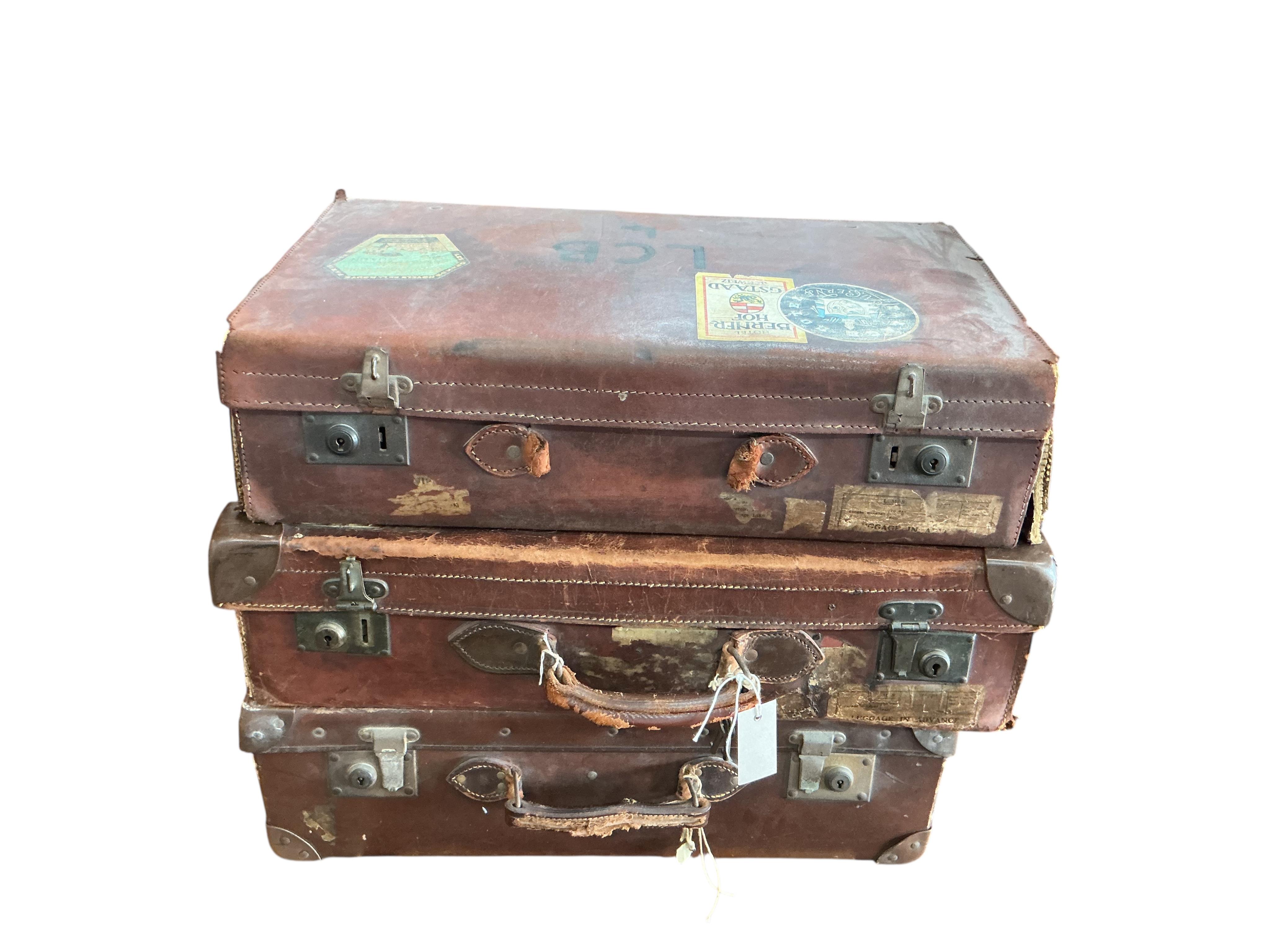 Three vintage suitcases, largest width 66cm